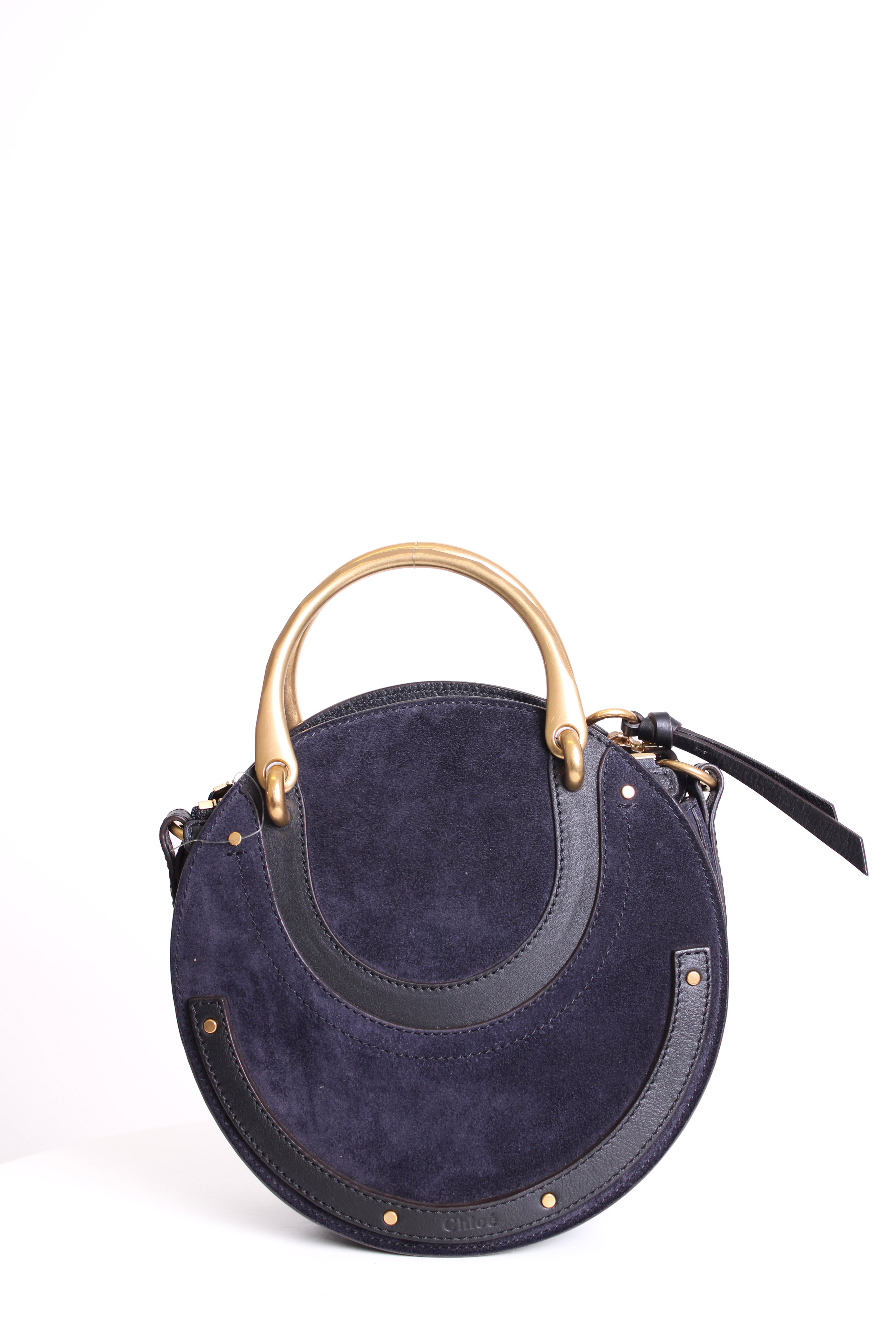 Navy blue handbag with gold handle on a white background